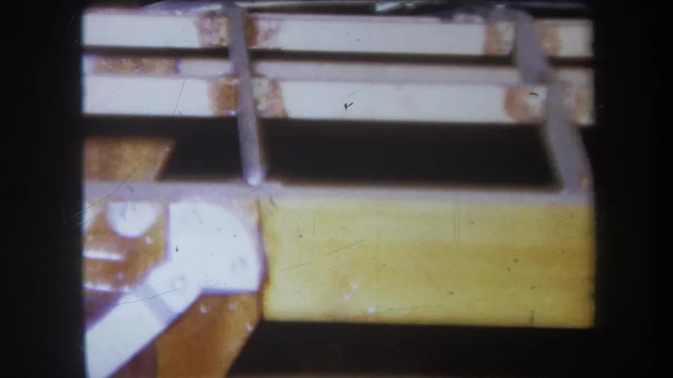 1964 Yucaipa frame showing a pale rail, yellow board, and exposed linkage or clamp on the workshop mechanism.
