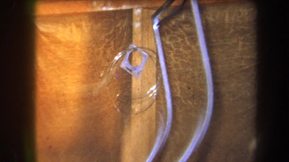 Warm 1964 8mm frame from Yucaipa showing hose loops beside a wooden board with a small plastic piece attached or nearby.