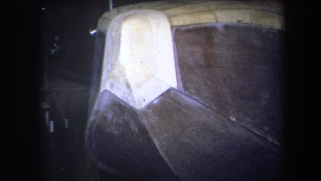 1964 Yucaipa home-movie frame with the camera closer on the white and brown sections of an unidentified geometric form.