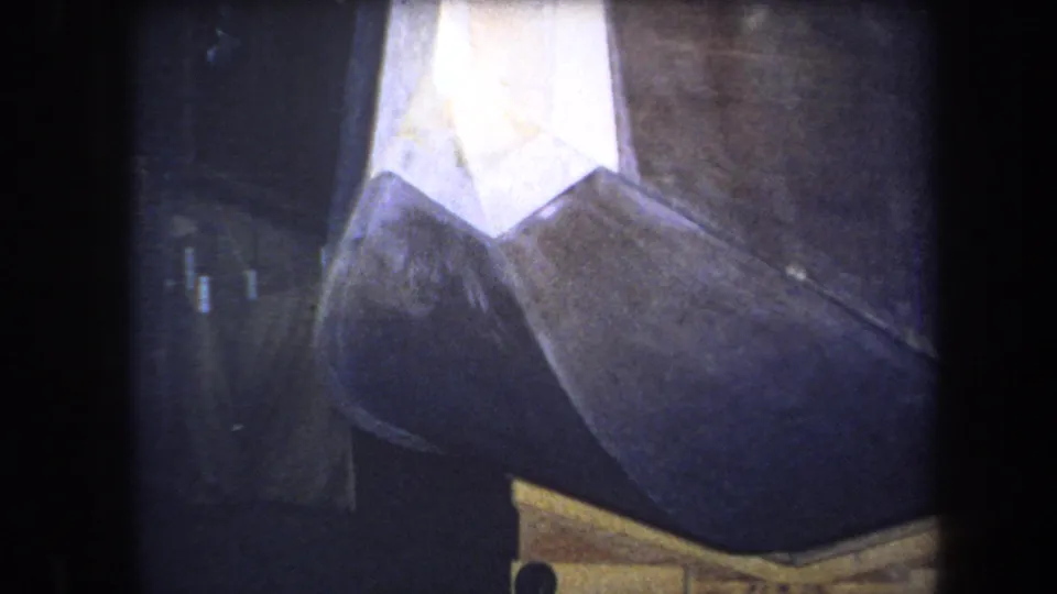 1964 Yucaipa home-movie frame showing a close crop of the unidentified geometric structure and its brown, white, and yellow areas.