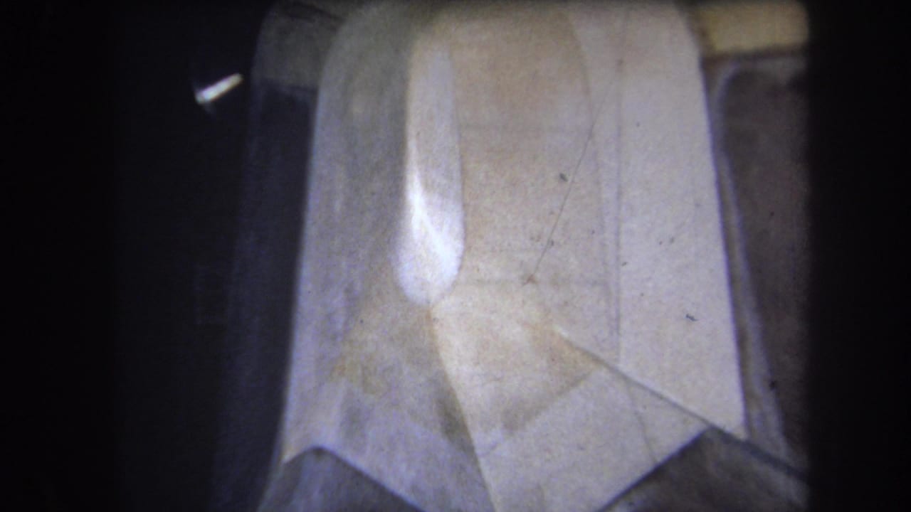 Pale plastic surface with folded-looking geometric panels and dark border.