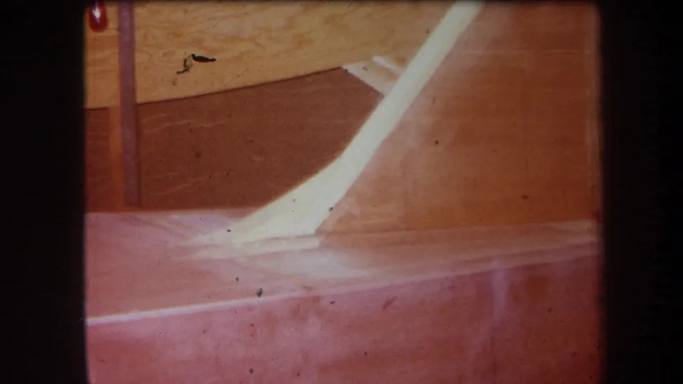 1964 Yucaipa-area 8mm frame showing the same unidentified wooden equipment detail with warm color and visible film marks.