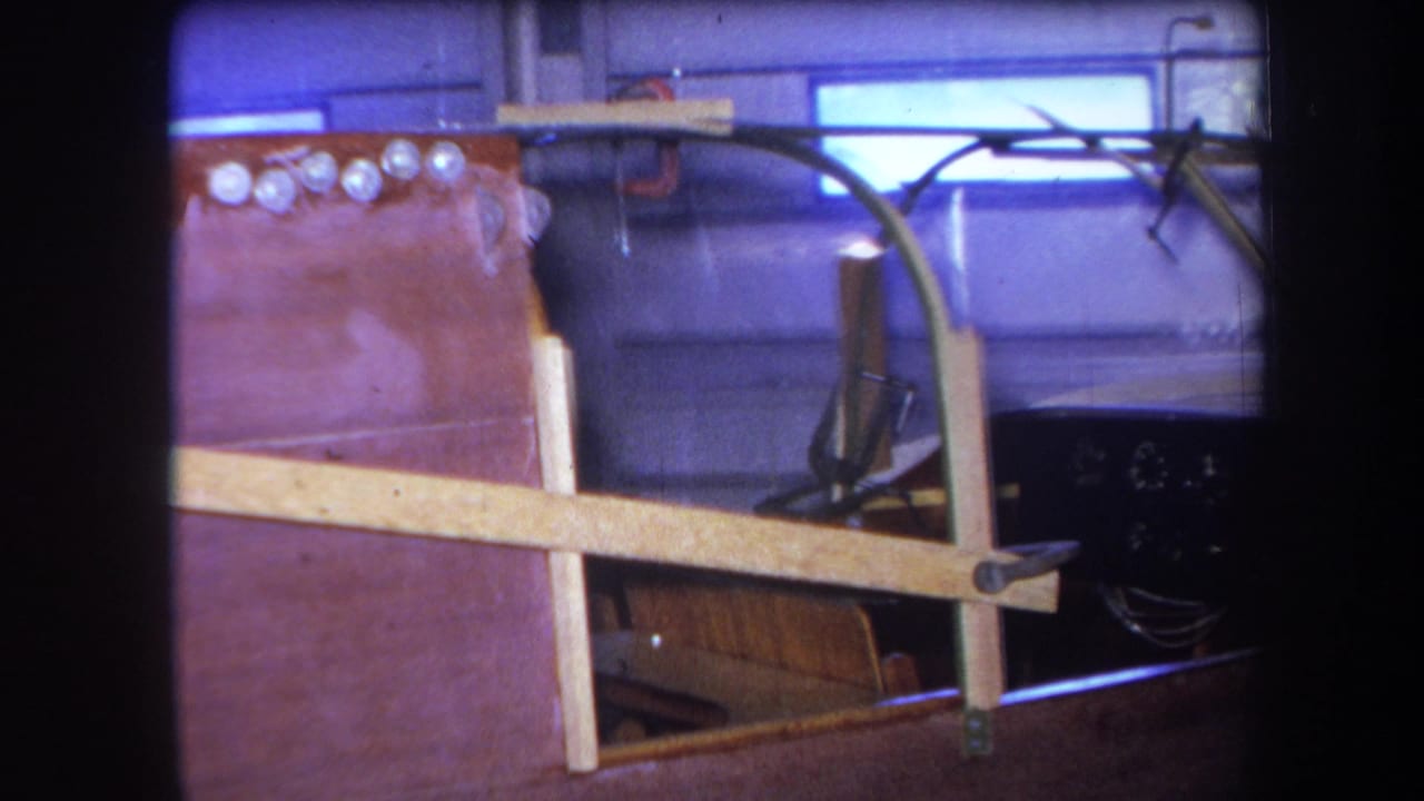 1964 Yucaipa garage frame showing a stripped vehicle chassis with wood bracing, metal bodywork, and exposed tubing or wiring.