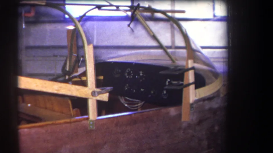 1964 Yucaipa-area frame showing the speedboat cockpit under construction, with gauges, wiring, canopy edge, and wooden garage supports visible.