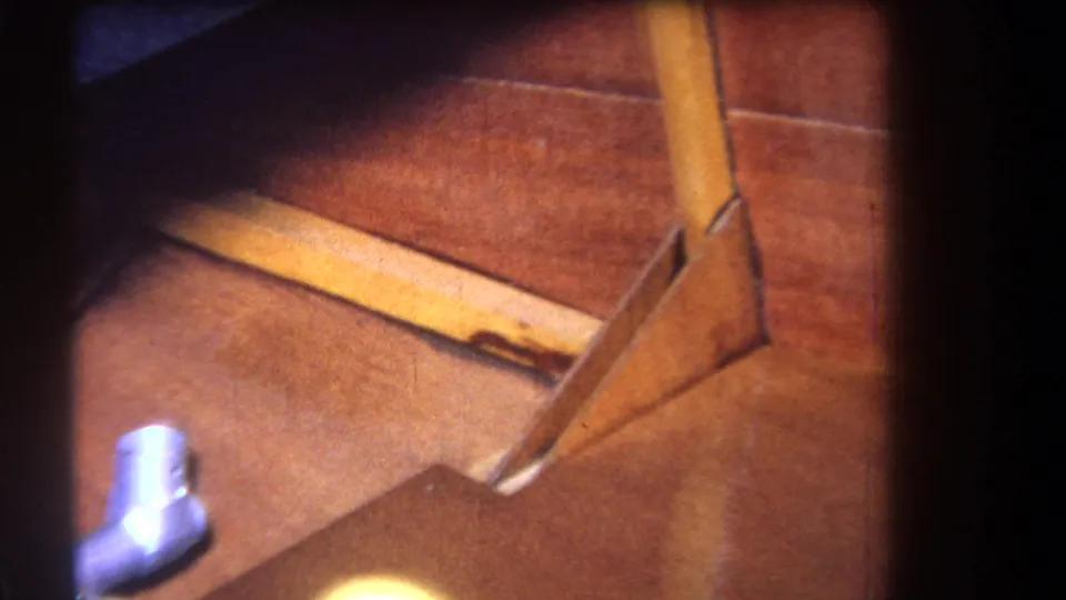 Interior 1964 Yucaipa frame showing wood framing, floor surface, and a small visible section of plumbing hardware.