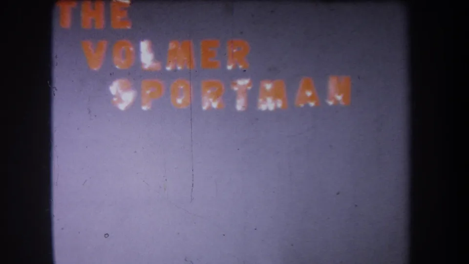 1965 Volmer Yucaipa 8mm frame showing The Volmer Sportsman lettering, with visible grain, scratches, and dark film edging.