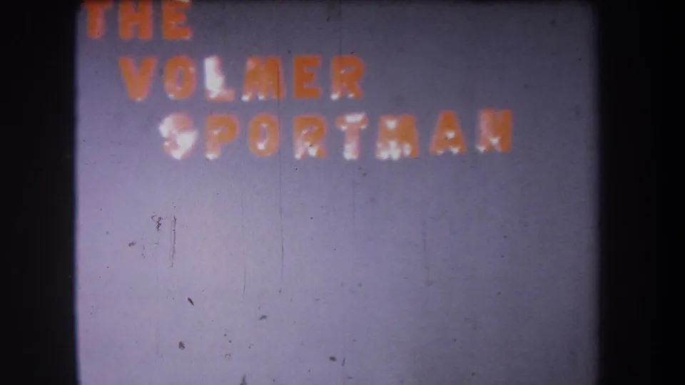 1965 8mm frame from Yucaipa showing The Volmer Sportsman text in red and white, softened by flicker, grain, and scratches.