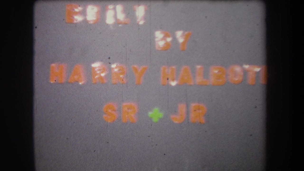 1965 home-movie title card for a family-built project, with orange lettering on a gray background.