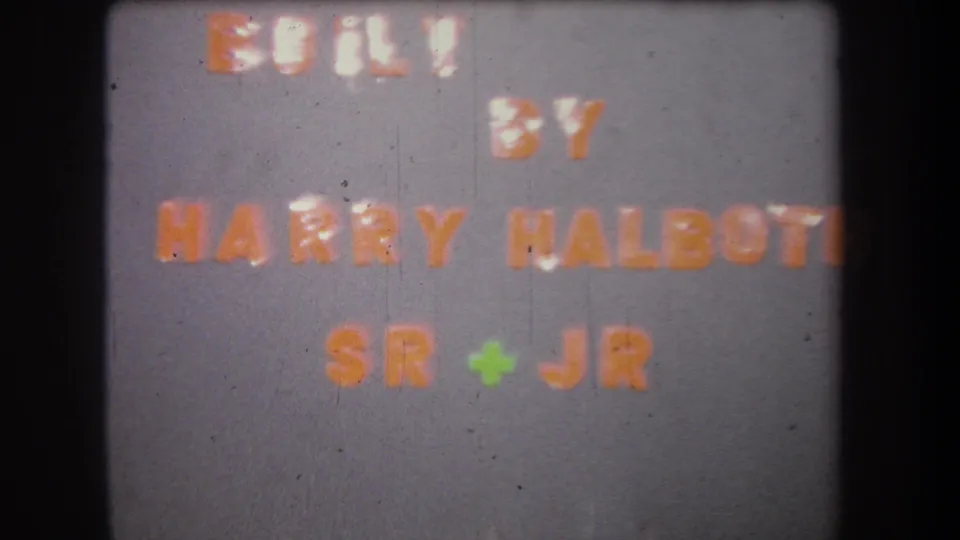 1965 home-movie title card for a family-built project, with orange lettering on a gray background.