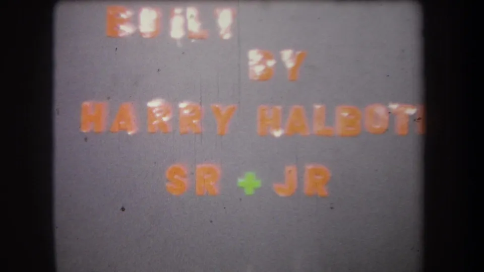 Repeated 1965 project title card naming Harry Halboti Sr and Jr, shown with faded 8mm color and soft focus.
