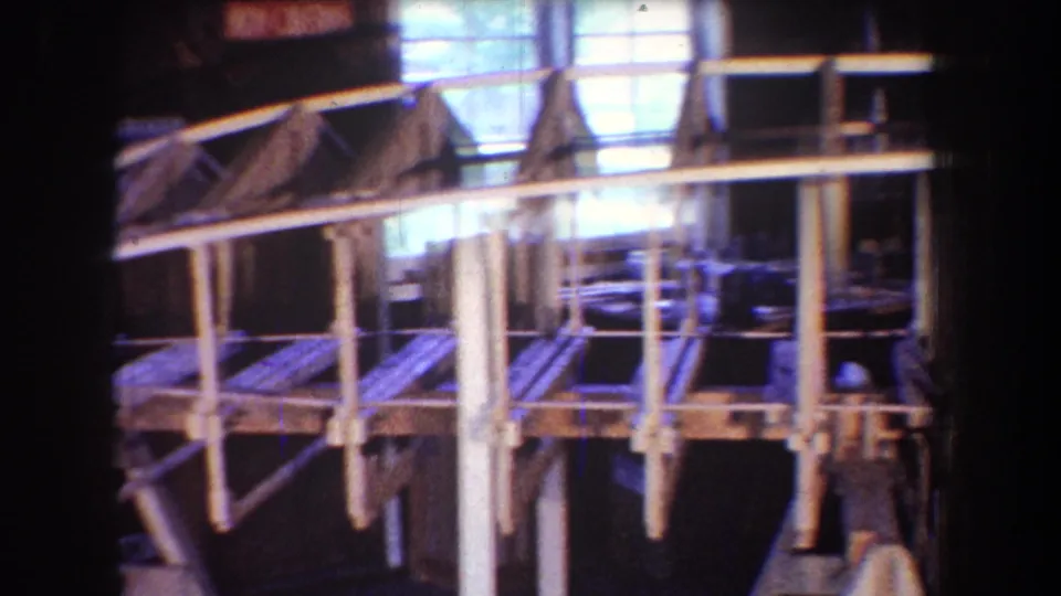 The 1965 Yucaipa workshop scene shows a large wood framework with posts, braces, and window light in the background.
