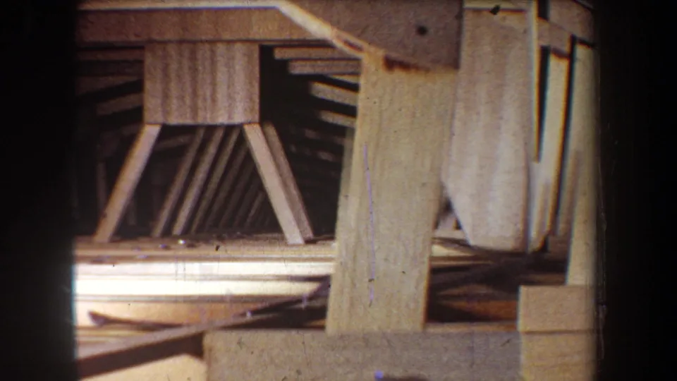 1965 Yucaipa frame showing a closer view of heavy wooden supports, diagonal bracing, and an unfinished interior structure.
