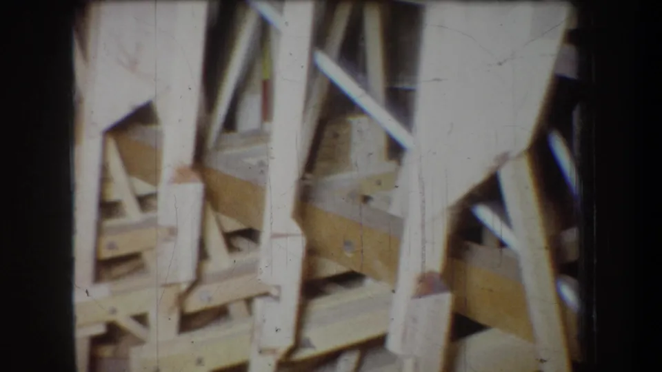 1965 Yucaipa frame showing a close view of pale wooden aircraft components, braces, and rail-like supports during construction.