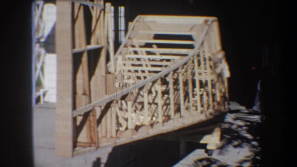 1965 Volmer Yucaipa frame showing the timber structure from the side, with a partially visible adult at the right edge.