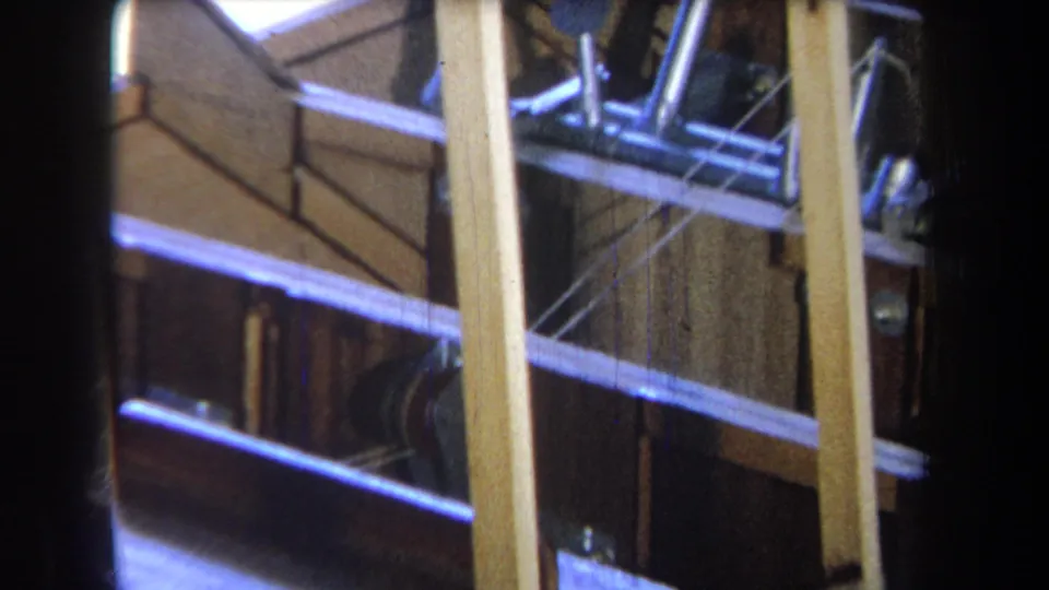 The final frame shows a close angled look at the unfinished boat frame, with pale supports, metal rods, and dark interior planking.