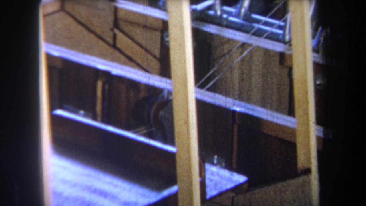1965 Yucaipa-area 8mm frame showing exposed wooden studs, braces, and dark unfinished interior spaces.