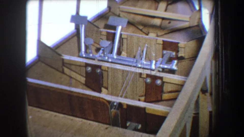 1965 8mm view of the unfinished Yucaipa structure, with boards, fittings, and diagonal framing visible.