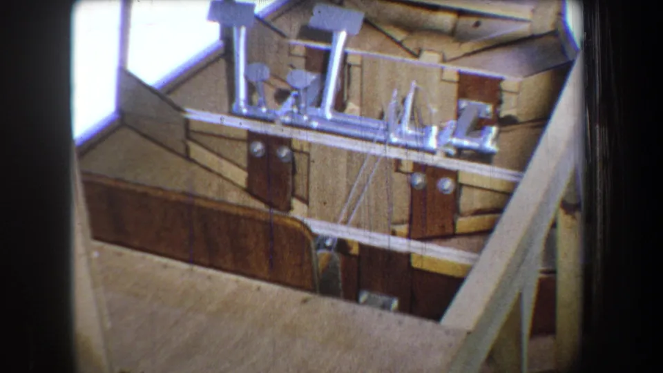 Final 1965 Yucaipa frame showing open wood construction, metal hardware, and daylight through the unfinished structure.