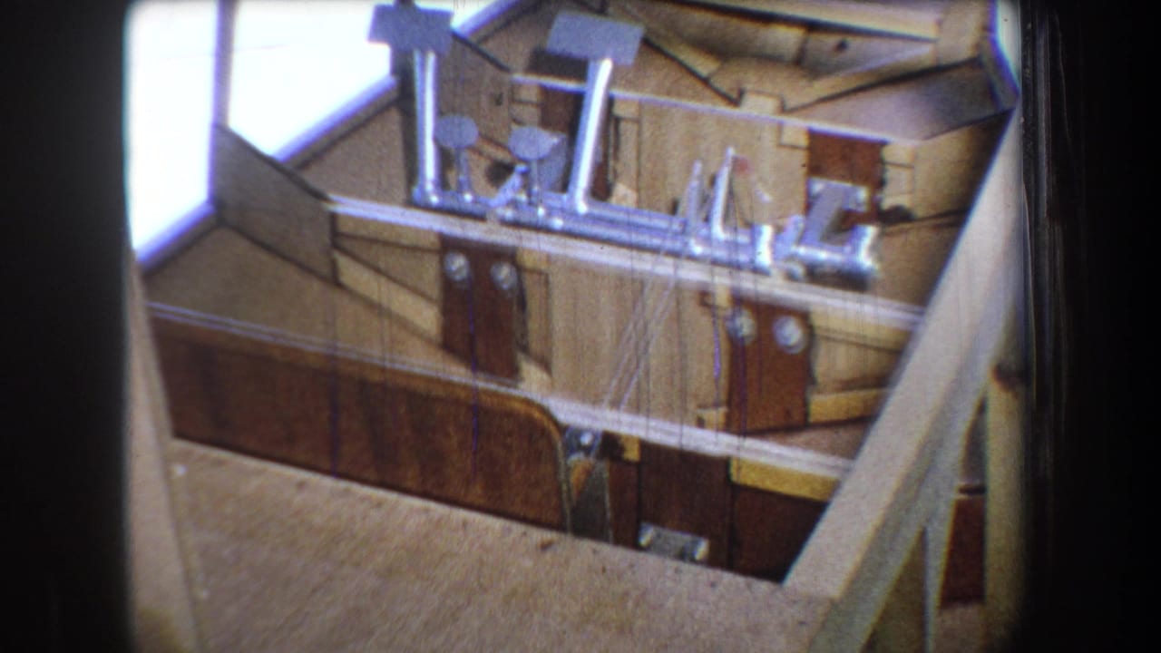 1965 Yucaipa 8mm frame showing a wooden boat interior with planked sides, fittings, and construction supports.
