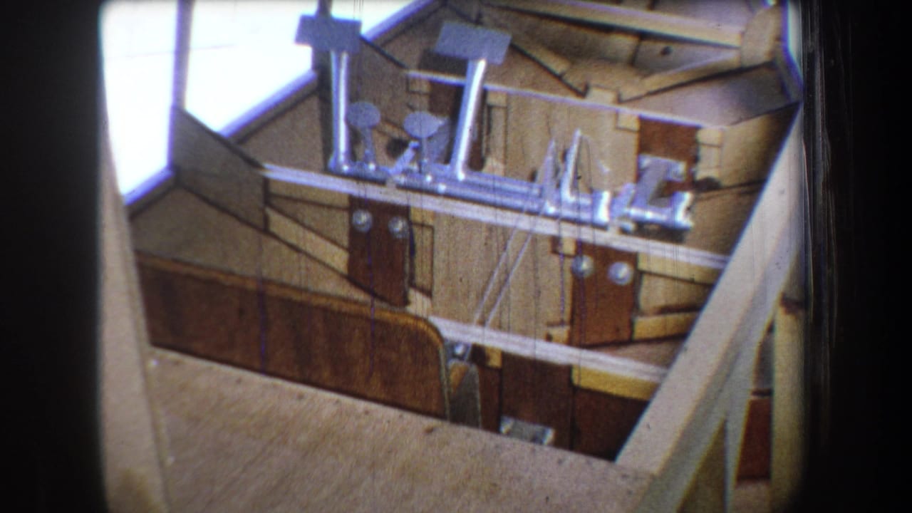 Similar view of a wooden boat interior with boards, fittings, and supports.