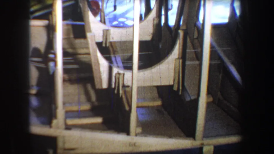 1965 Yucaipa 8mm frame showing curved wooden boat ribs, vertical rods, and the narrow interior structure.