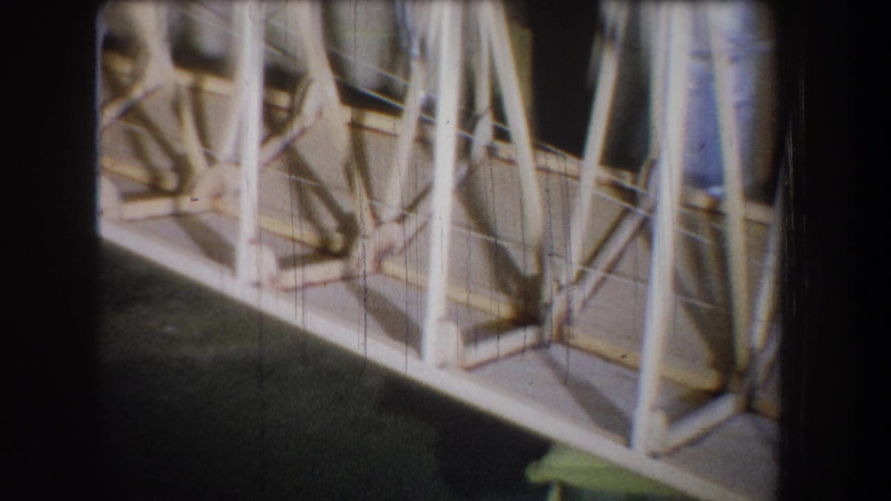 Wooden framework with vertical and diagonal supports seen from a close angle.