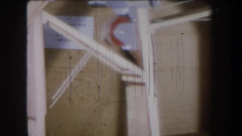 1965 Yucaipa construction close-up with diagonal wood bracing, a red curved mark and visible vertical film scratches.