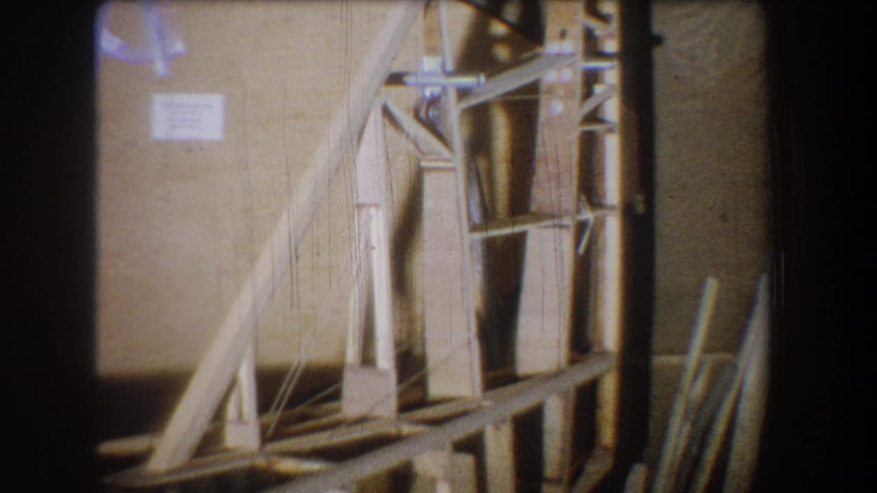 Closer view of the wooden model with triangular bracing and vertical supports.