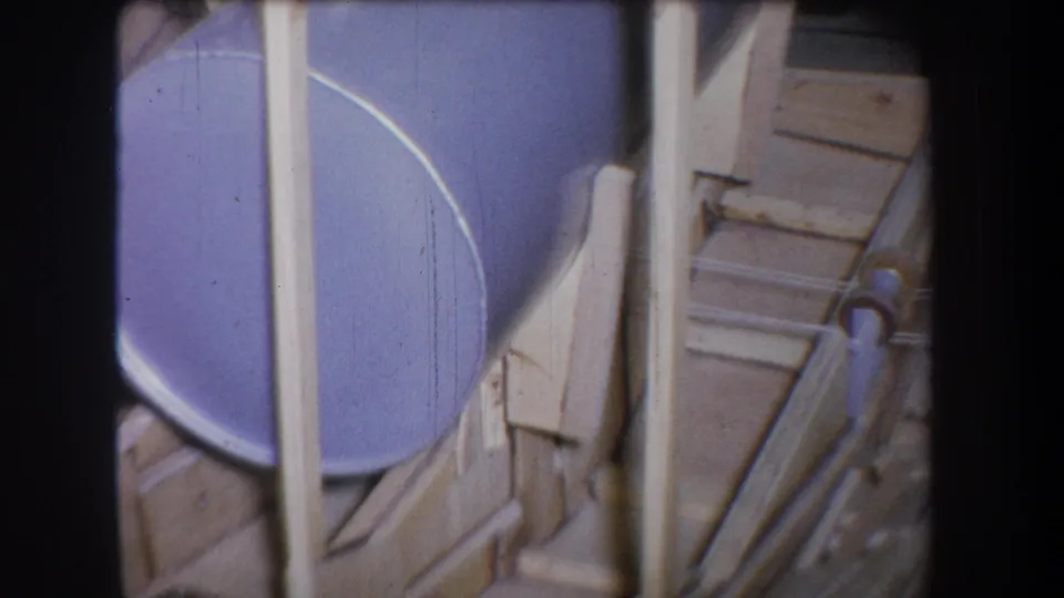 Final frame of the 1965 Yucaipa industrial clip, showing the purple tank edge, pipework, and pale structural supports.