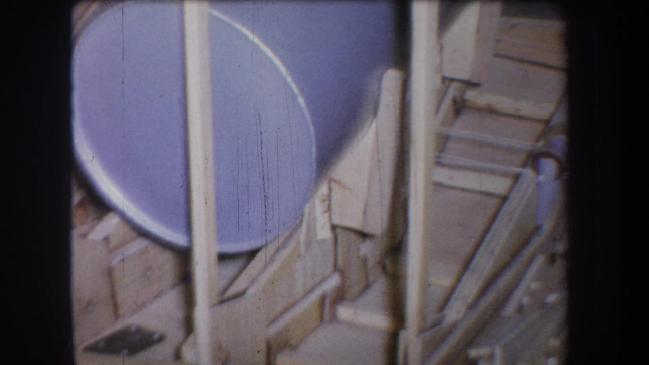 1965 Yucaipa 8mm frame showing a blue drum partly enclosed by wooden posts and metal structural pieces.