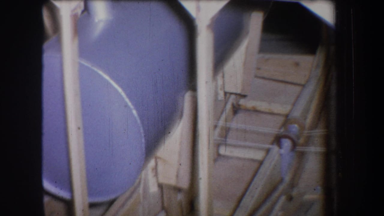 Blue drum framed by pale wooden uprights and angled supports.