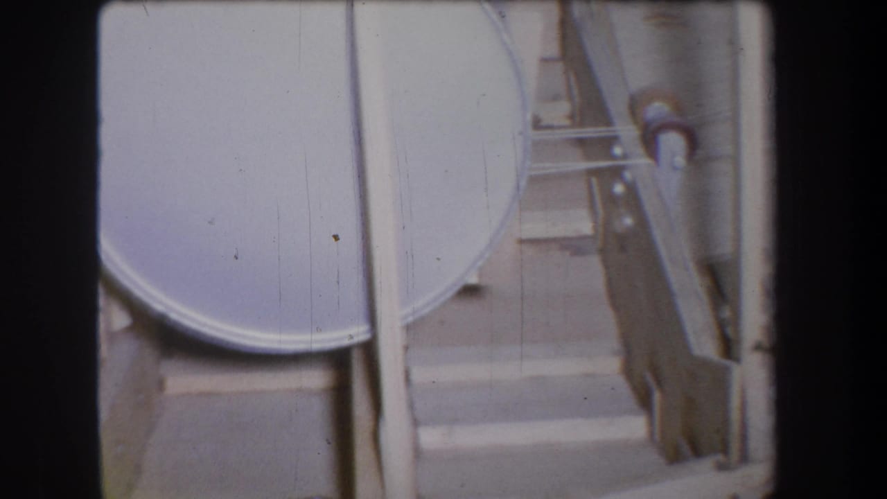 A gray cylindrical tank and nearby pipes and braces appear in the 1965 Yucaipa industrial inspection footage.