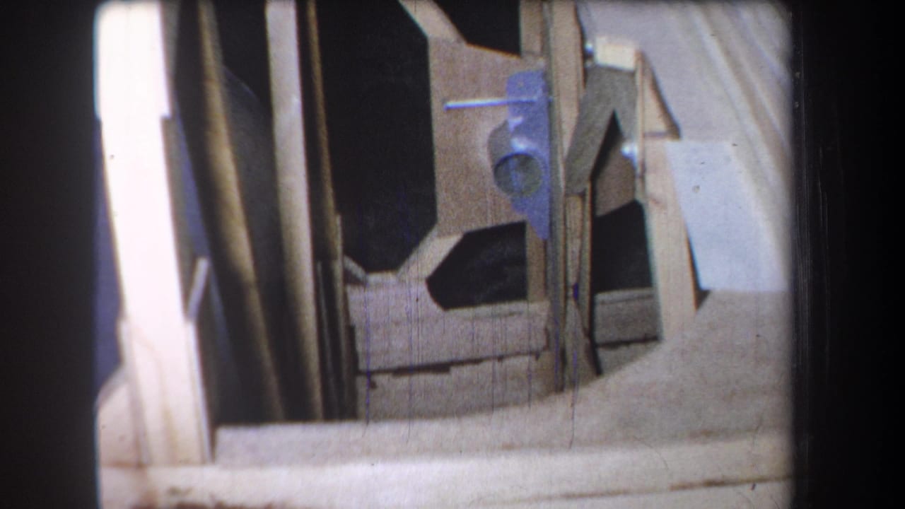 Similar close framing view with vertical lumber, angled board edges, and dark interior openings.
