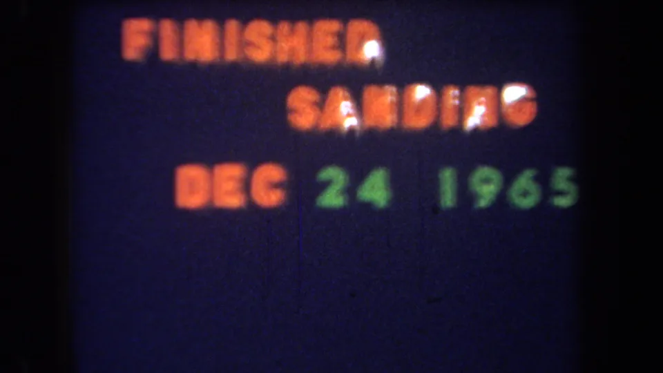 Final sampled frame of the 1965 projected title card, retaining soft focus, dark background, and colored date lettering.