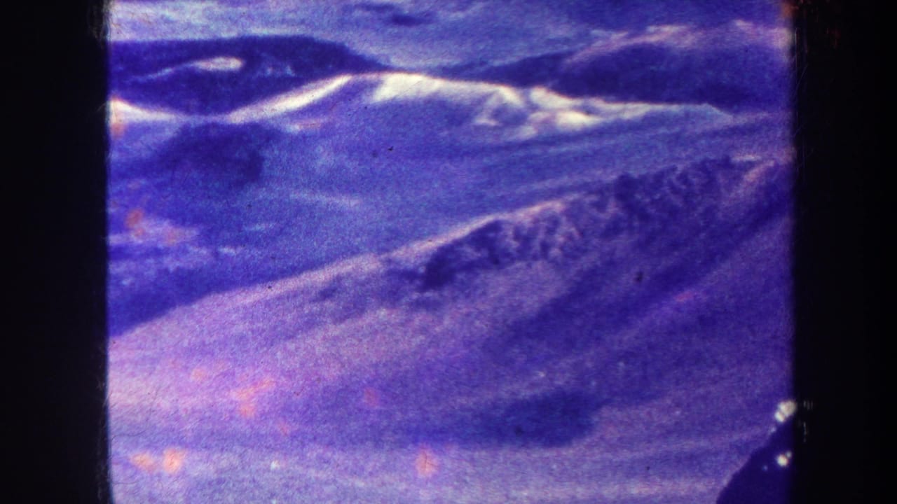 Blue-purple mountain ridges seen through dark 8mm frame borders.