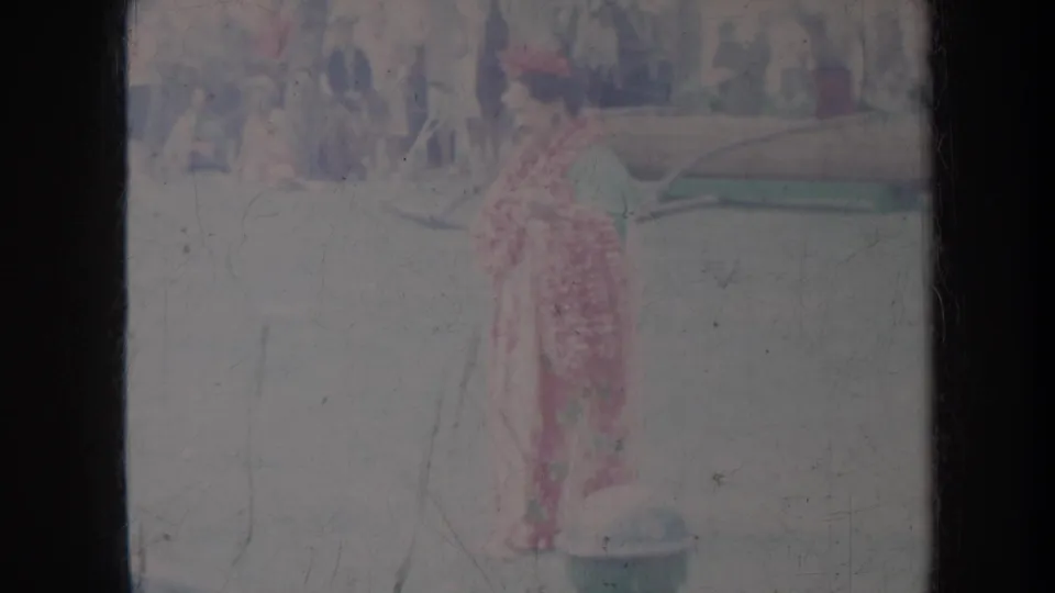 1967 Honolulu frame showing a solo dancer in a red full-length patterned dress, filmed from a spectator's 8mm viewpoint.