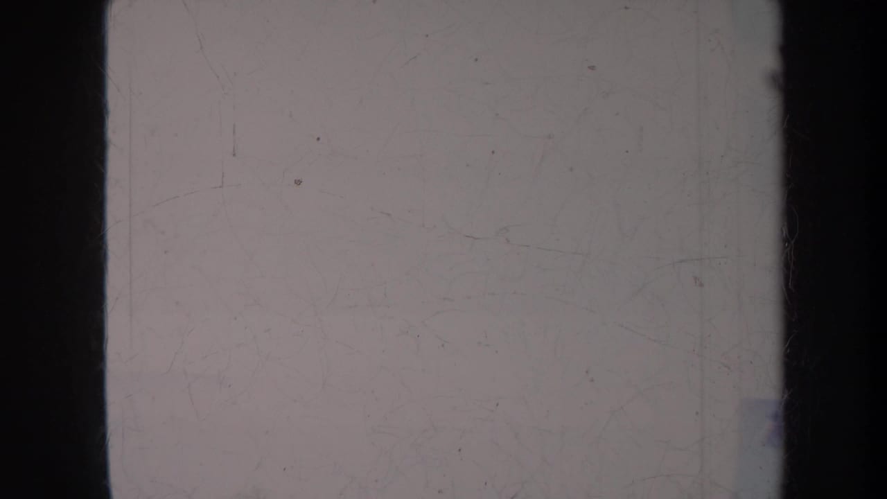 Mostly pale sky and water with dark vertical film border at the side.
