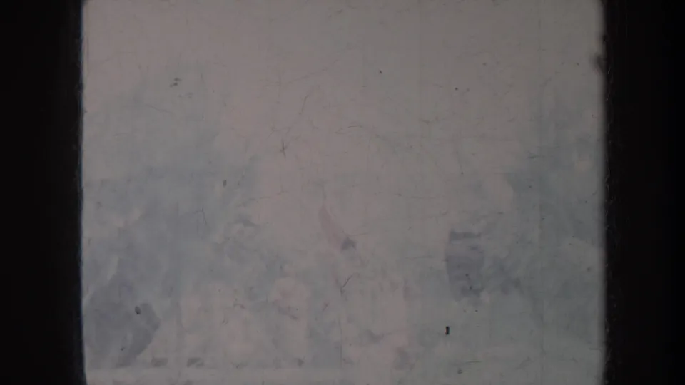 1967 Honolulu 8mm frame with a hazy, faded outdoor view, heavy scratches, dust, and dark film-frame edges.