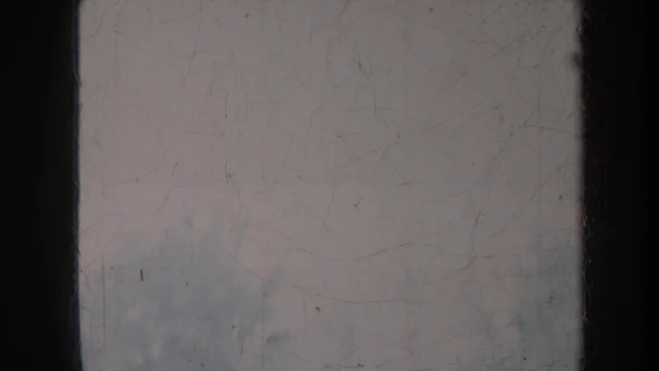 Faded 1967 Honolulu 8mm frame with dark side borders, dust, scratches, and indistinct mottled outdoor forms.