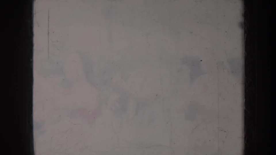 Lower 8mm frame from Honolulu, 1967, with faint seated forms, soft exposure, and visible surface damage across the film.