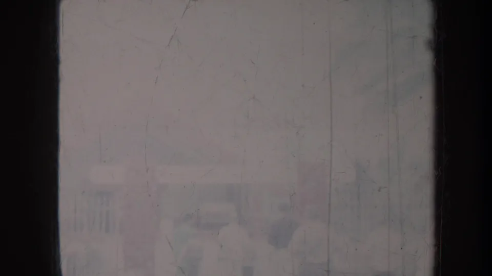 The closing 1967 Honolulu frame contains barely visible figures or structures, with the scene largely obscured by aged 8mm damage.