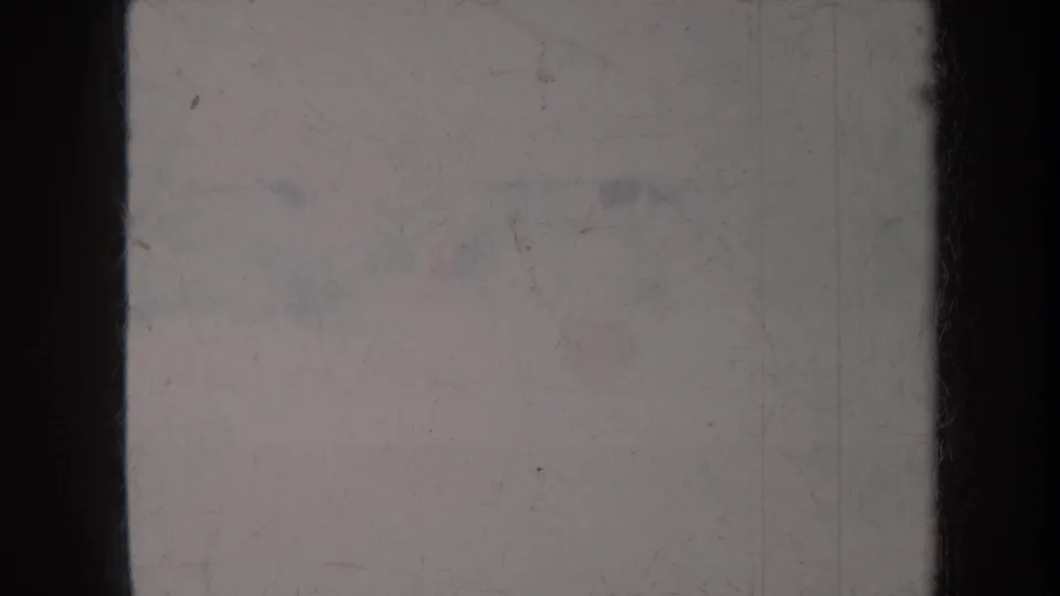 Overexposed 1967 Honolulu home-movie frame with faint thatched-setting detail, pale color, scratches, and soft focus.