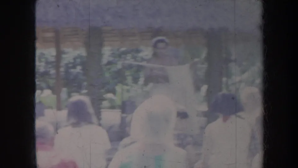 Tourists at a Honolulu resort face a thatched area where a partially visible Tahiti sign appears among foliage and faded film texture.