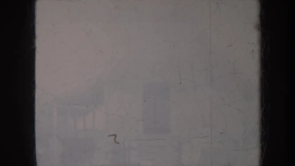 1967 Honolulu home-movie frame showing a faint standing dancer and seated guitarist in an outdoor setting with heavy fading and scratches.
