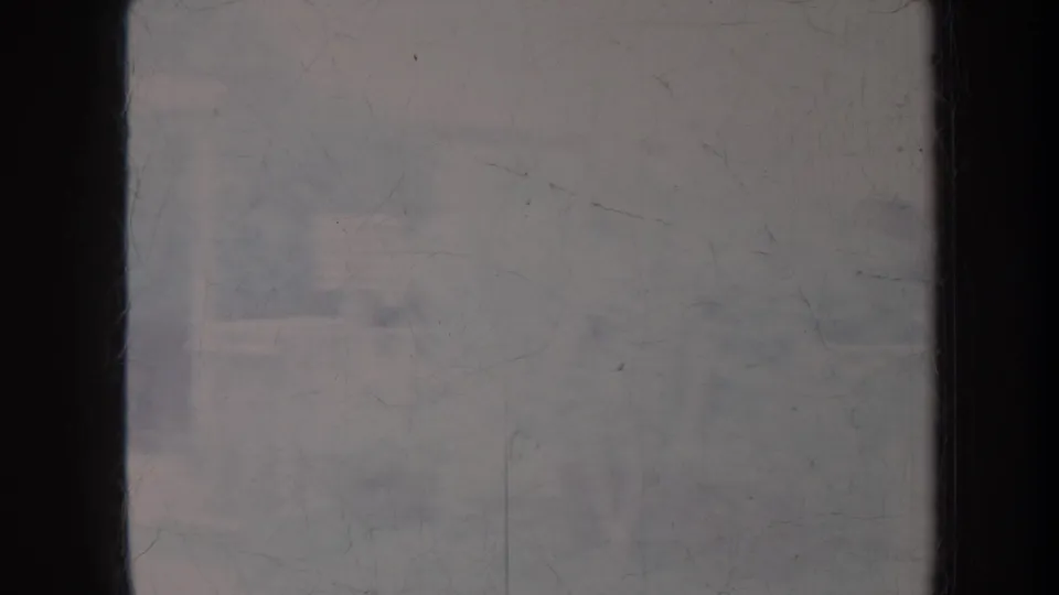 1967 Honolulu frame showing a washed-out view through glass with faint structural outlines and visible film scratches.