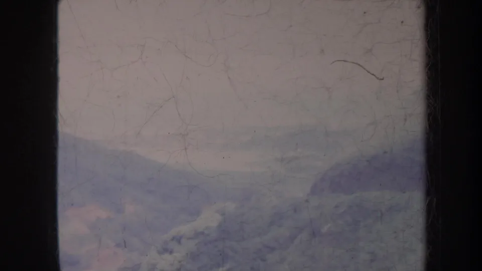 Faded 1967 Hawaii home-movie view of a soft mountain landscape, partly obscured by haze and film wear.