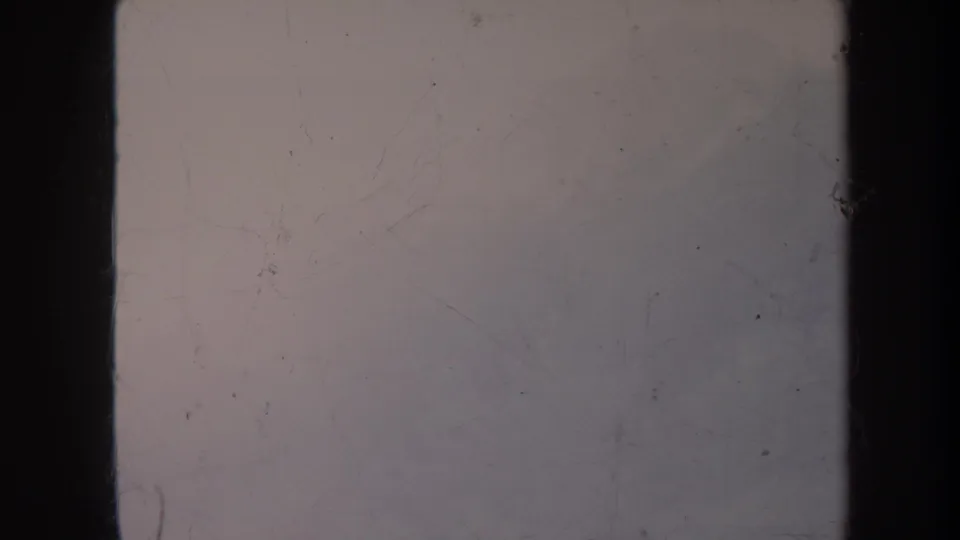 1967 8mm frame dominated by fog and faded color, with a faint slope and dark film edge visible.