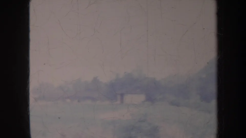 Soft 1967 Honolulu landscape view with a hazy hillside, pale sky, scratches, dust, and dark film border at the right edge.