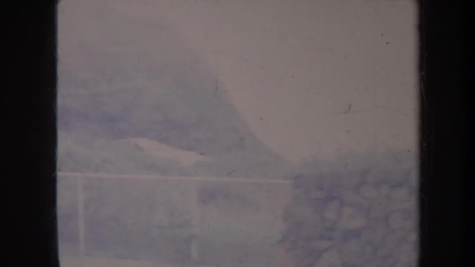 Faded 1967 Honolulu 8mm frame showing a pale railing, indistinct wall or landscape texture, and heavy soft focus with visible film wear.