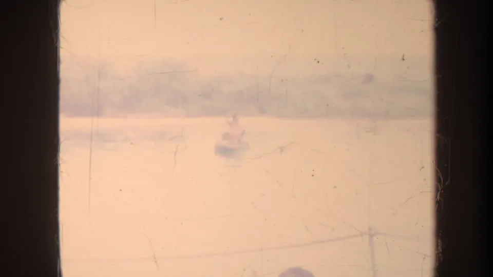 Faded sepia-toned 1967 Honolulu water view with a small distant boat, soft horizon, scratches, and aged 8mm film texture.